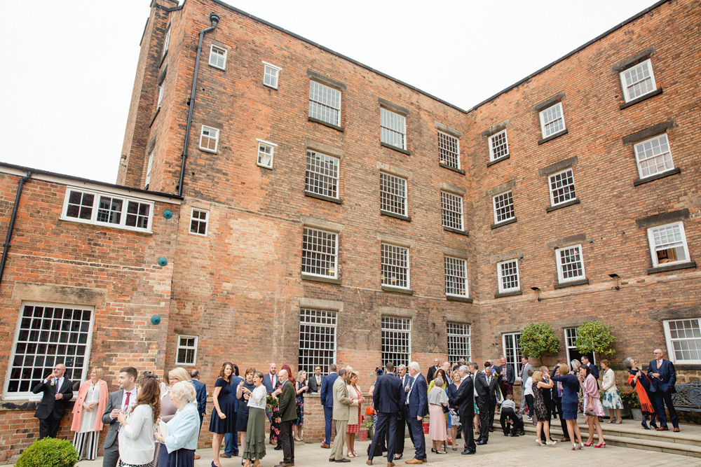 guests in the courtyard at west mill wedding venue derby